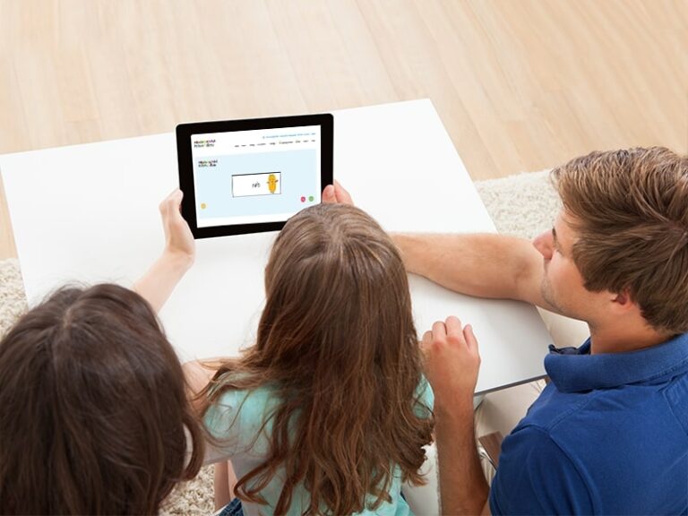 Parents sitting with child completing the Monster Phonics free online phonics screening check tool on their iPad at home